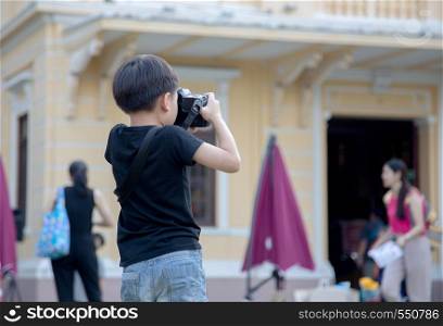 find talent of kids with real practice as boy take photo with camera to improve skill.