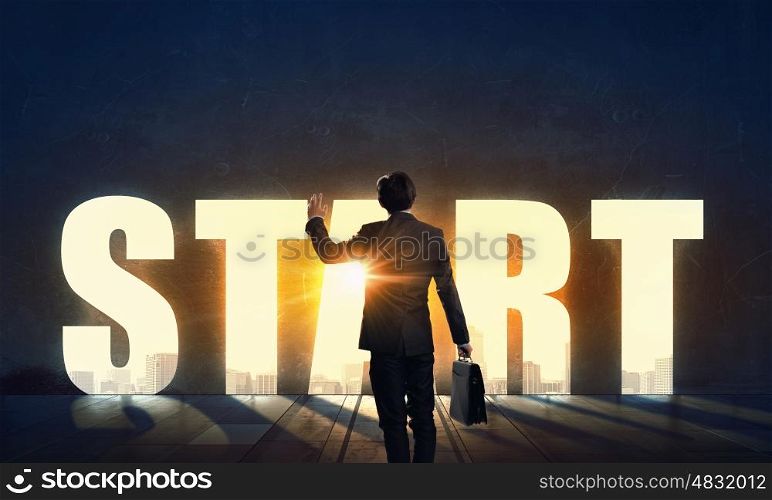 Find your business motivation. Back view of businessman standing in light of conceptual word