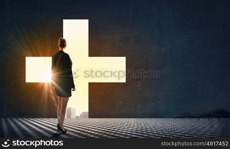 Find your business motivation. Back view of businesswoman standing in light of buconceptual word