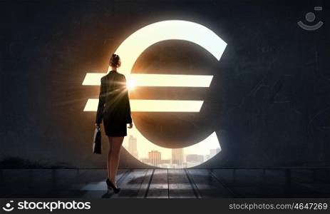 Find your business motivation. Back view of businesswoman standing in light of business conceptual word