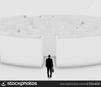 Finding solution. Businessman standing near the enter of labyrinth