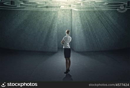 Finding solution. Businesswoman standing near the enter of labyrinth