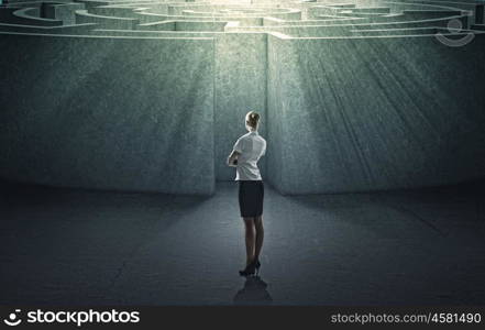 Finding solution. Businesswoman standing near the enter of labyrinth