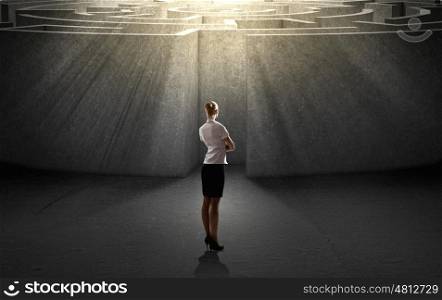 Finding solution. Businesswoman standing near the enter of labyrinth