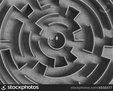Finding solution. Top view of businessman standing in center of labyrinth
