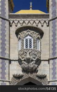 Fine 17th century sculpture of mythological triton, symbolizing the creation of the world. Above the main entrance door in the Pena National Palace at Sintra near Lisbon in Portugal.