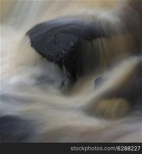 Fine art landscape detail image of water flowing over rocks