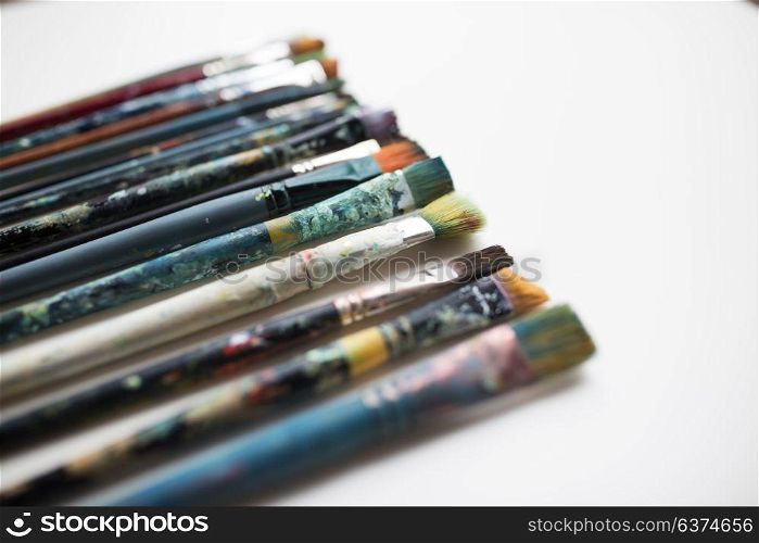 fine art, painting, creativity and artistic tools concept - dirty paintbrushes. close up of dirty paintbrushes