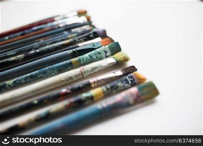 fine art, painting, creativity and artistic tools concept - dirty paintbrushes. close up of dirty paintbrushes