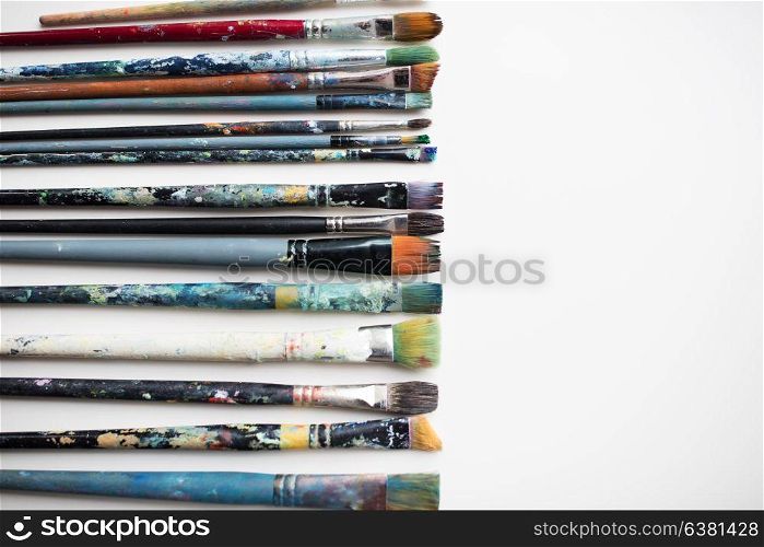 fine art, painting, creativity and artistic tools concept - dirty paintbrushes from top. dirty paintbrushes from top