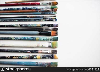 fine art, painting, creativity and artistic tools concept - dirty paintbrushes from top. dirty paintbrushes from top