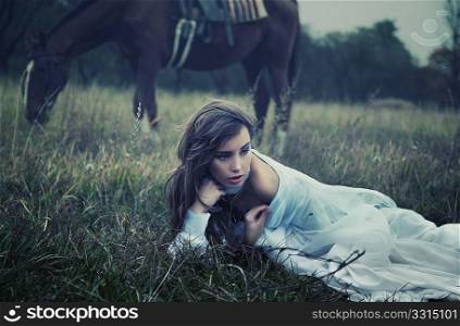 Fine art photo of a young beauty on the grass