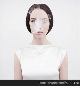 Fine art portrait of a beautiful lady with cigarette smoke