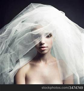 Fine-art portrait of elegant girl in veil