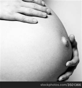 Fine art studio photo of young pregnant woman