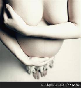 Fine art studio photo of young pregnant woman