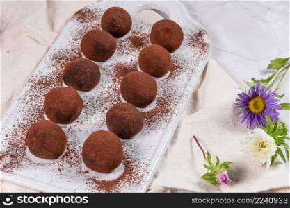 Fine chocolate truffles on white ceramic plate