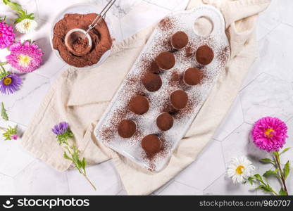 Fine chocolate truffles on white ceramic plate