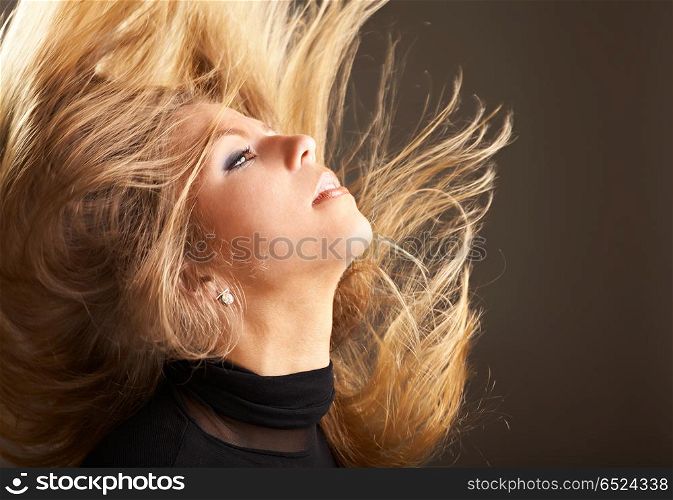 Fine long hair of the girl flutter in movement. Fluttering hair
