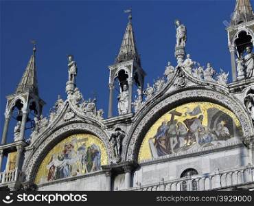 Fine mosaics and detailed statues on the Basilica in St Marks Square in Venice. Italy