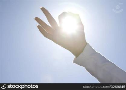 Finger encircling the sun