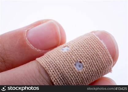 finger in white bandage on a white background