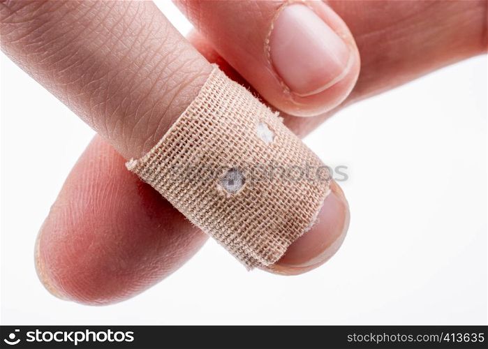 finger in white bandage on a white background