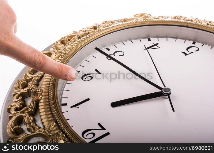Finger pointing to clock on a white background