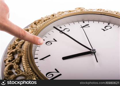 Finger pointing to clock on a white background