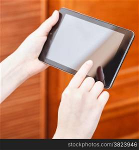 finger pressing tablet pc screen in office