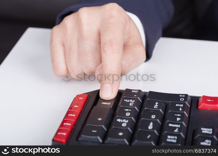 finger pushing enter button on a keyboard of computer