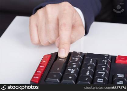 finger pushing enter button on a keyboard of computer