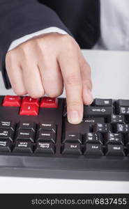 finger pushing enter button on a keyboard of computer