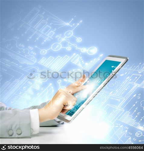 Finger touch. Close up image of human hand touching screen of tablet pc