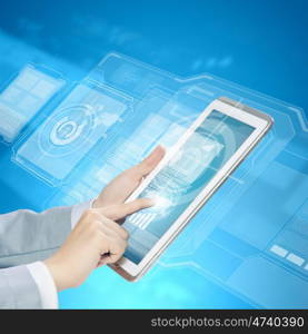 Finger touch. Close up image of human hand touching screen of tablet pc