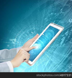 Finger touch. Close up image of human hand touching screen of tablet pc