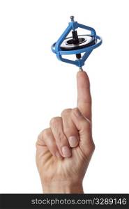 Finger with a spinning gyroscope on white background