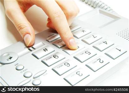 finger with grey telephone keypad
