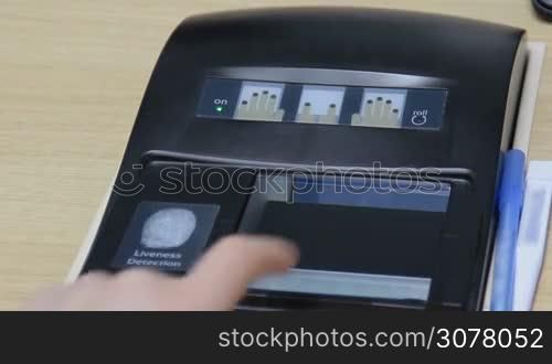 Fingerprint scan provides security access with biometrics identification. Close-up of female touching screen with finger for granting access.