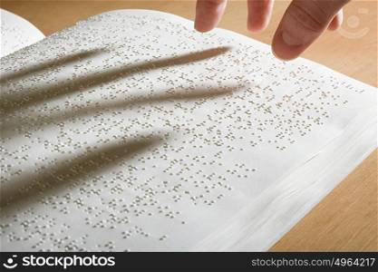 Fingers above a braille book