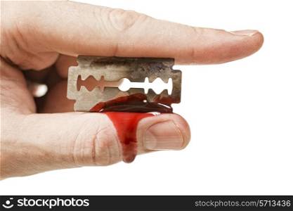 fingers keep the old rusty razor with blood on a white background