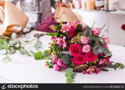 Finished bouquets on the table in the flower shop. Finished bouquets on the table