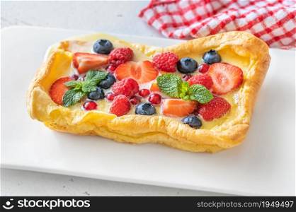 Finnish pancake topped with fresh berries and mint