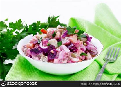 Finnish Rosoli salad of herring, beets, potatoes, pickled or pickled cucumbers, carrots, onions and eggs, dressed with mayonnaise in a bowl on wooden board background