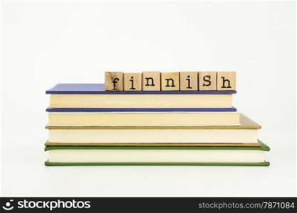 finnish word on wood stamps stack on books, language and academic concept