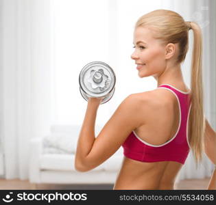 fintess, healthcare and dieting concept - young sporty woman with heavy steel dumbbell