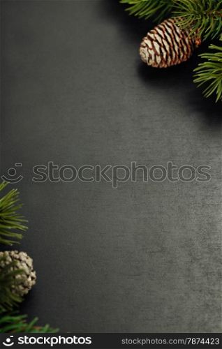 Fir branches with cones on wooden background