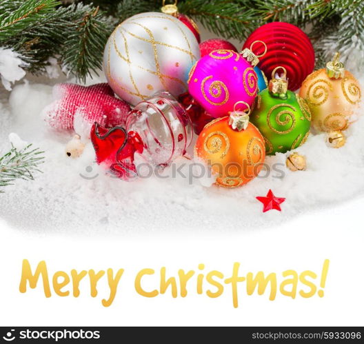 fir tree and multicolored christmas balls. multicolored christmas balls on white snow with copy space