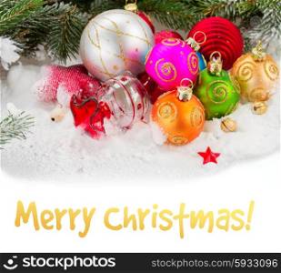 fir tree and multicolored christmas balls. multicolored christmas balls on white snow with copy space