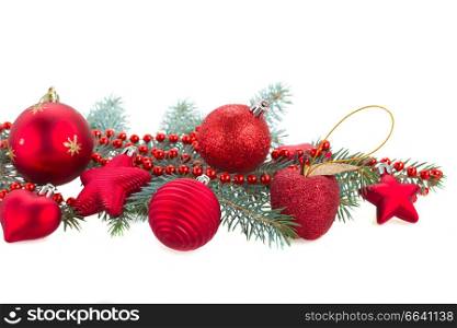 fir tree branch and red christmas decorations isolated on white background